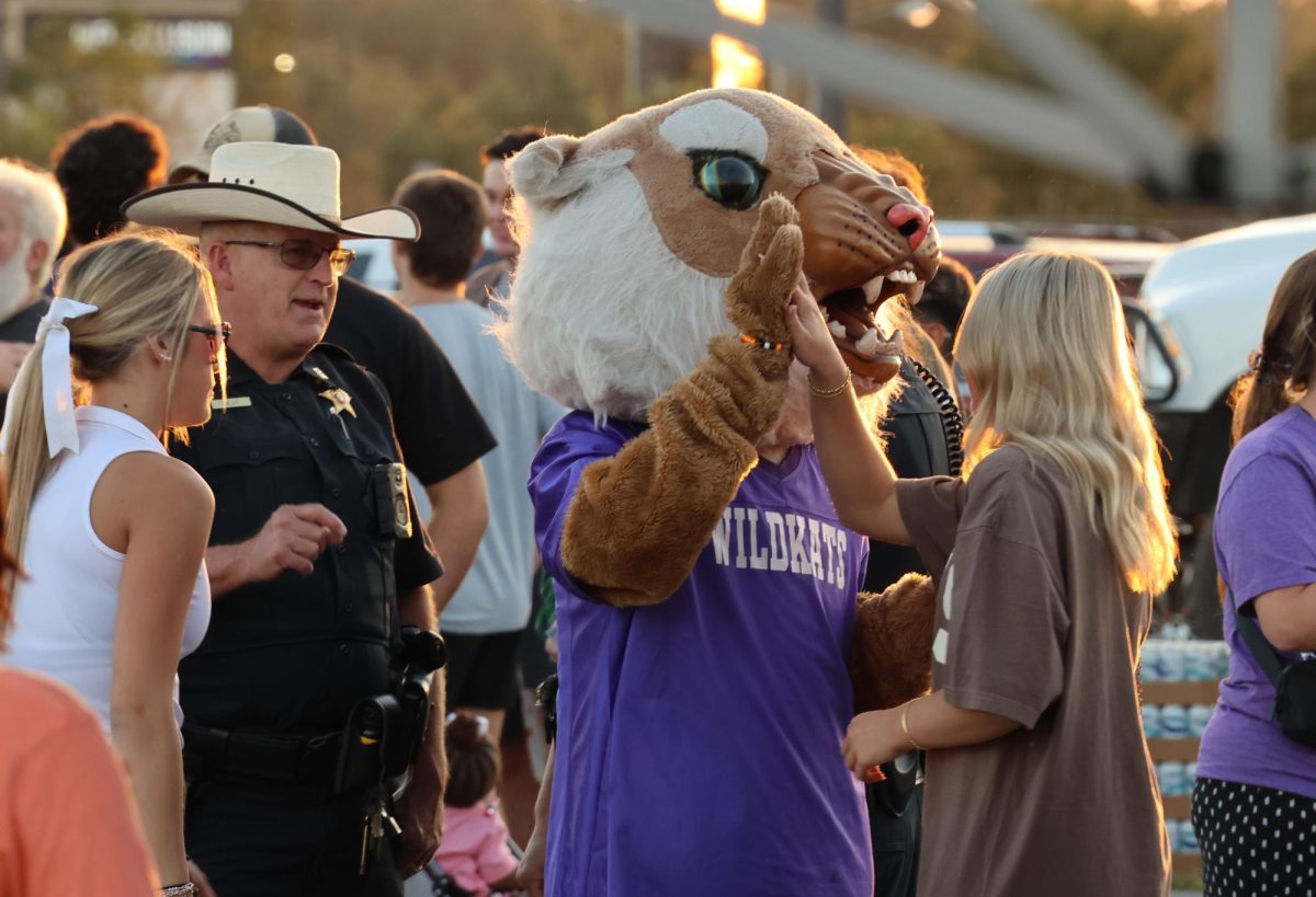 UP TOP. Freshman Maddox O’Hagen spreads school spirit around while also sharing his faith at Fields of Faith with Willis High School, by high-fiving other peers at the event while in his mascot uniform.
