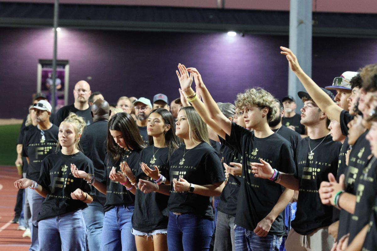 HANDS HELD HIGH AND PROUD. Fields of Faith has sophomores Kamden Fralish and Kinsey Tedder with their hands out welcoming all of the joy and happiness of the lord into their hearts.