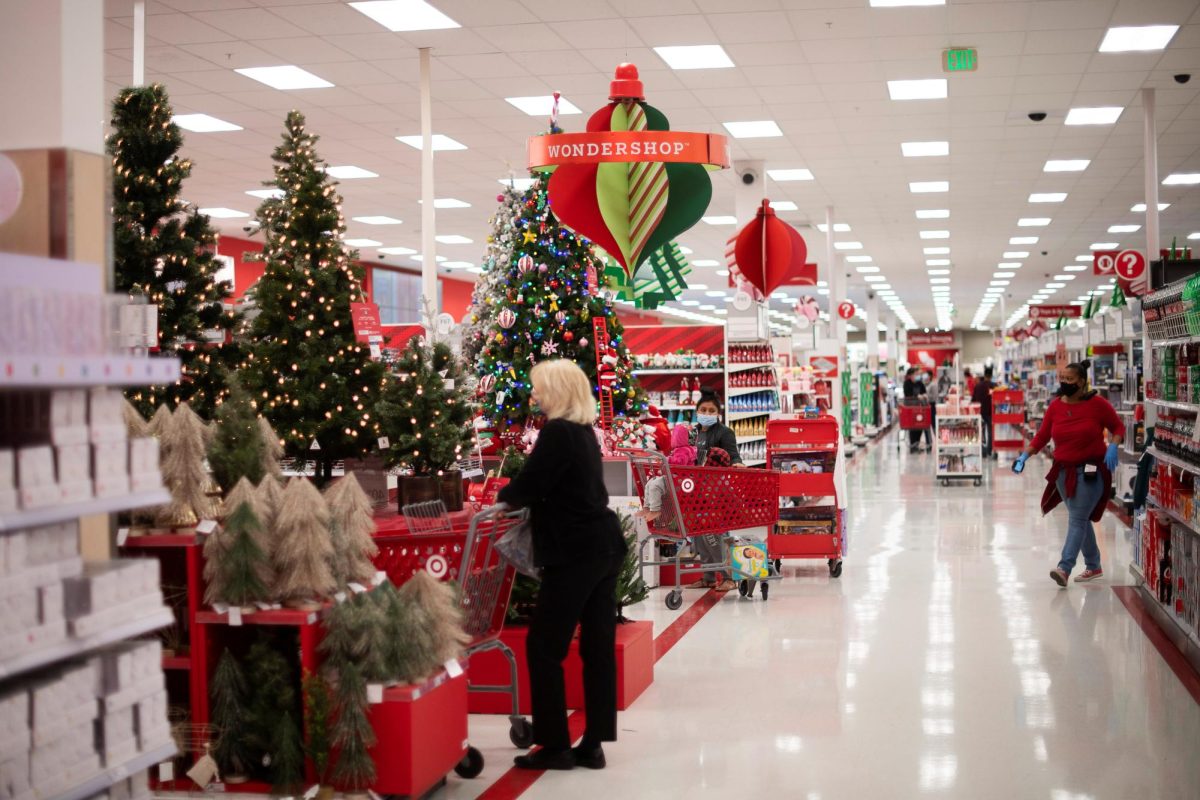 Shoppers browse merchandise beside a Christmas tree display at a Target store in King of Prussia, Pennsylvania U.S. November 20, 2020. REUTERS/Mark Makela