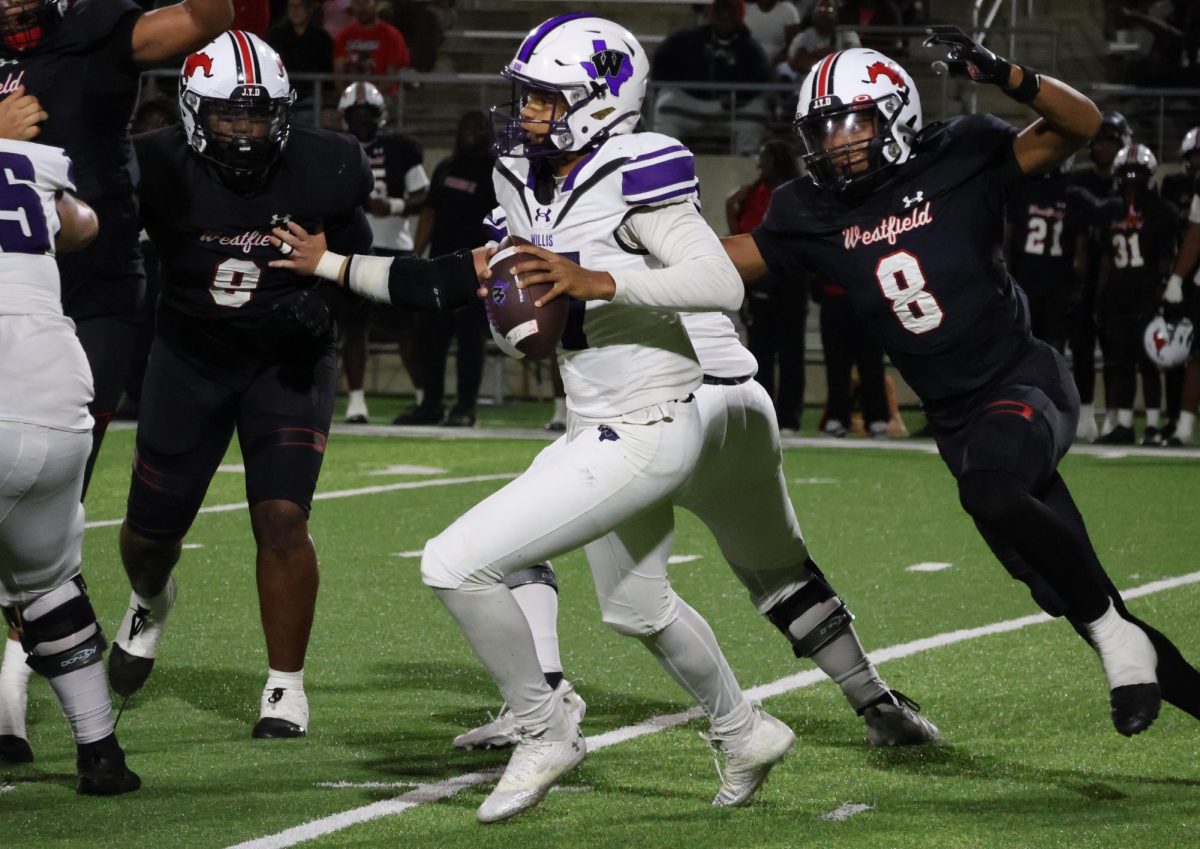 MOVING THE BALL. Running down the field, freshman Lincoln Frazier dadges players to gain a few yards for the offense. 