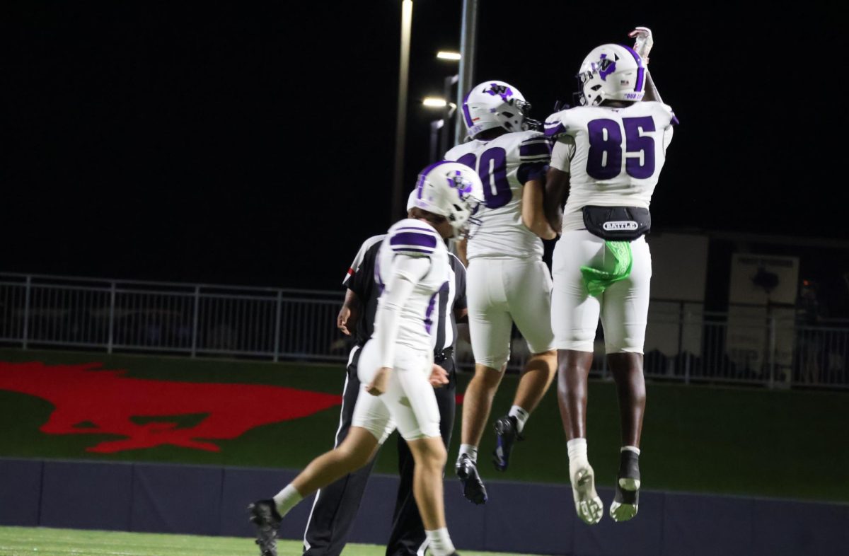 WILLIS PRIDE. After successfully getting points on the board, seniors Jaivon Martin and Alec Hargis celebrate in the air. The tight end and kicker duo are vital players to the team's success, and will continue their teamwork against Tomball. 
