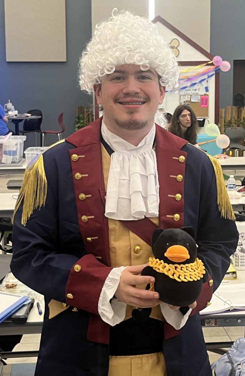 COSTUMES ALLOWED. As a winner of the Boovitational costume contest, senior Josh Miller shows off his prize.