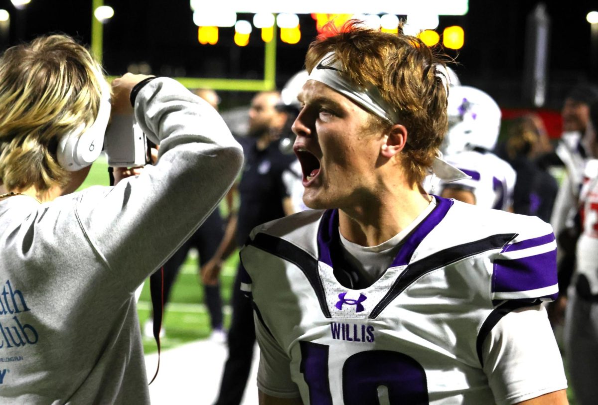 KEEP ON GOING. Walking down the sidelines, senior Carter Williams yells to the players on the field to make it down the field for a touchdown. During the intense game between Westfield and Willis, the final score after a back and forth game was 23-20.
