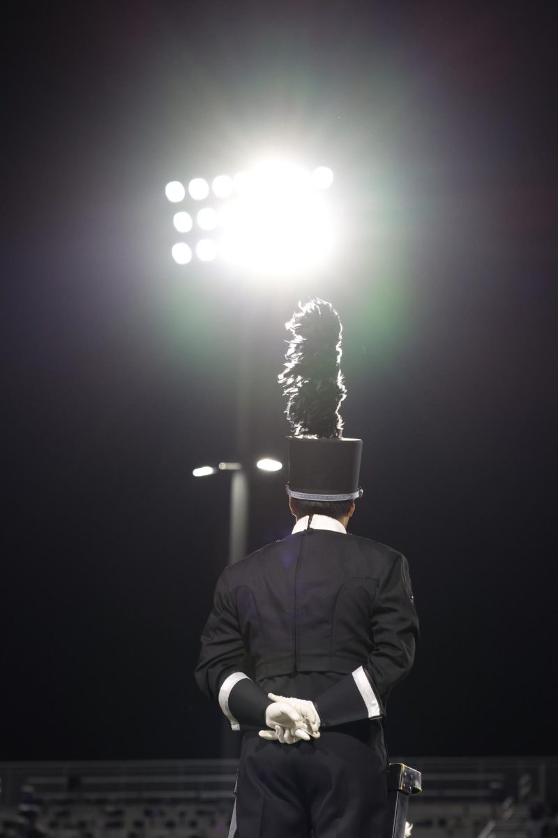 ATTENTION. Preparing to lead the band for their halftime performance, junior Nickolaus Cerda stands proudly ready to conduct. The Willis Marching band had a successful season with a sweepstakes at Districts, and making it to compete at Area. 
