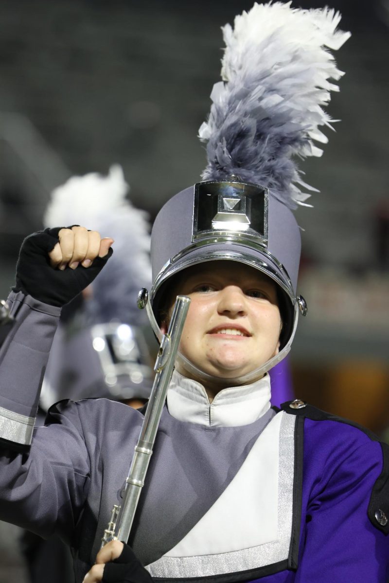 PLAY TO WIN. During the band's halftime show freshman Annley McClaine cheers on the Wildkats. . The band attends each game witht he color guard to cheer from the stands and show off their talent at half time. 