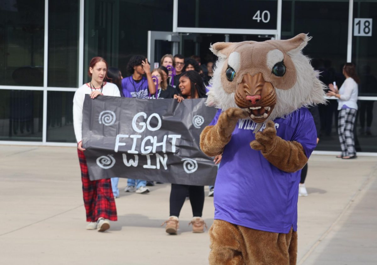LEADING THE WAY. Willie the Wildkat takes the lead as the Walk of Champions leaves the CTE building and heads to the main building. The Walk Of Champions celebrated the groups who recently had success including AFJORTC, band, choir, cheer, FFA, PitKats, Sweethearts and varsity football. 