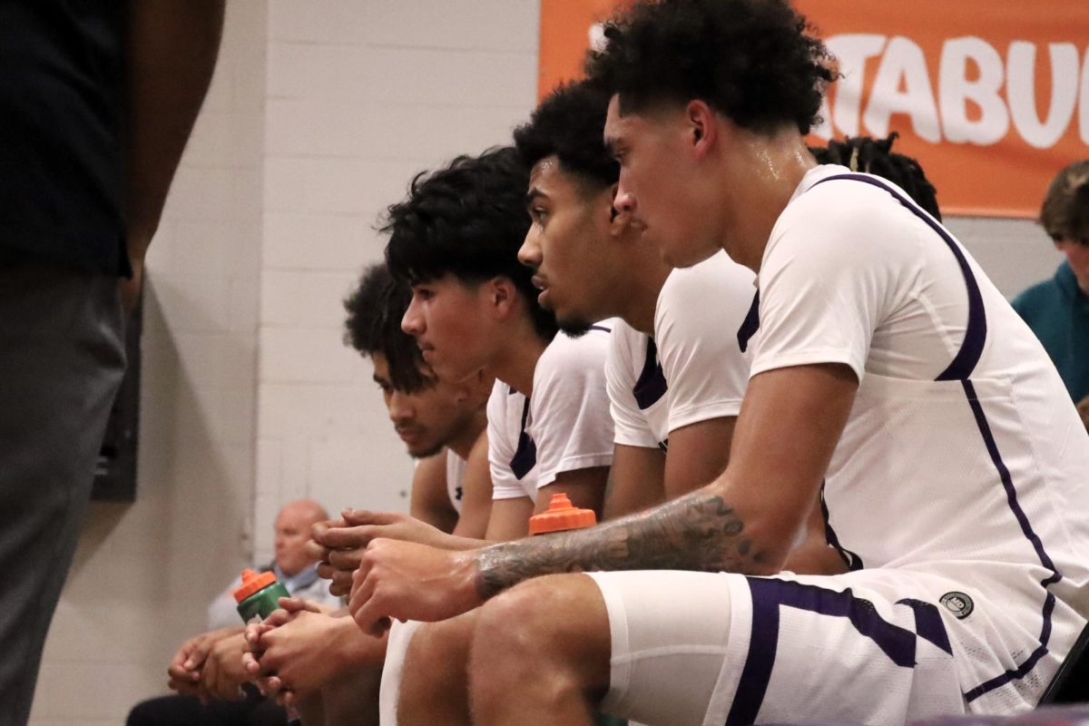 TIME OUT KATS. Creating a quick game play juniors Drake Manney, Orlando Sanchez, senior SJ Young and junior J'Lynn Kellow take a quick break from the game against The Woodlands. The Kats fought hard but lost against the Highlanders 64-62.