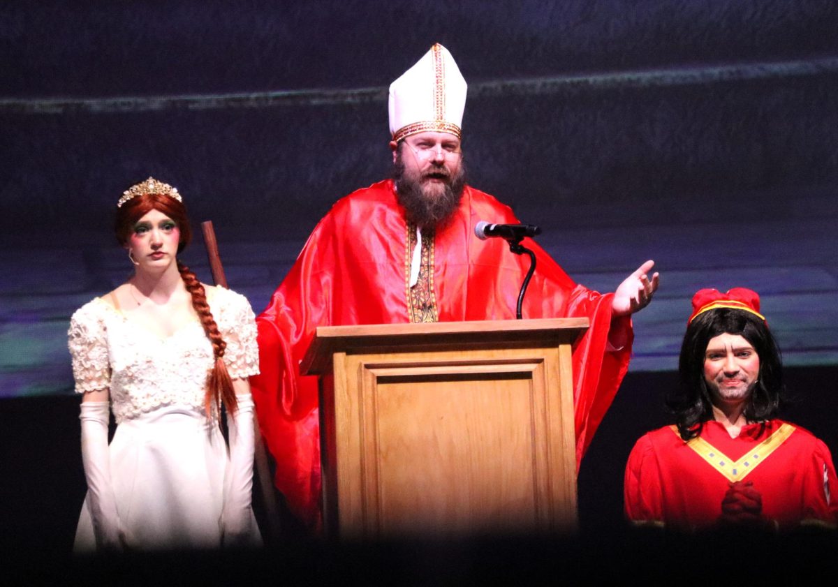 MARRIAGE MISHAPS. Fiona (sophomore Sophia Von Kuschembahr), the Bishop (teacher Chris Slovak) and Lord Farquard (sophomore Austin Montalbano) begins the marriage scene that is foiled by Shrek and his mob of fairy tale creatures. 