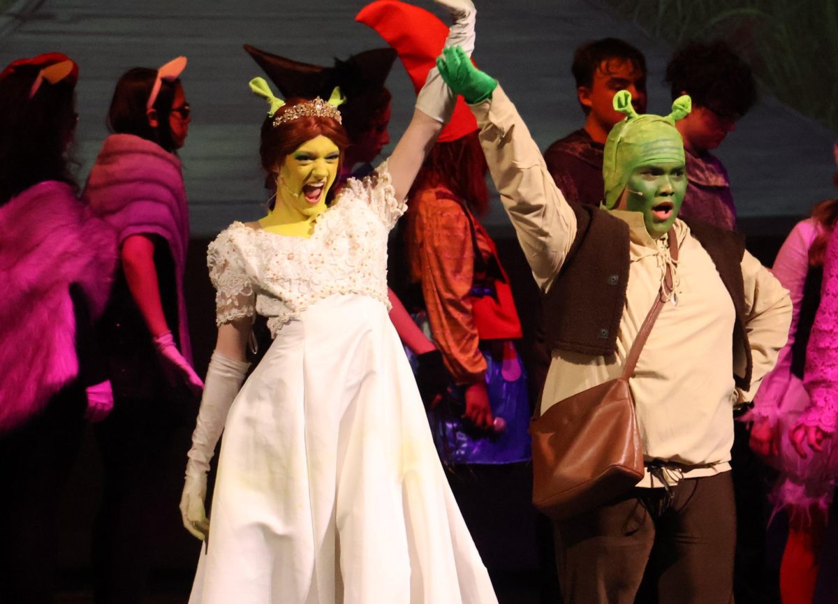 HAPPILY EVER AFTER. During the closing number of "Shrek," sophomore Sophia von Koschembahr and senior Jhun Abarquez play the roles of Fiona and Shrek. The musical is scheduled for Friday at 7 p.m. and Saturday at 2 p.m. The Saturday evening performance has been cancelled because of weather concerns. photo by Mia McGowen