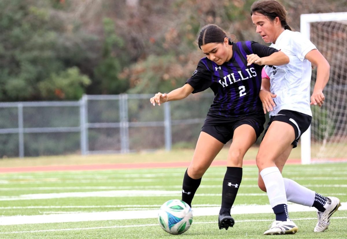 FIGHTING TO WIN. During the Kat Kup held Jan. 8-10, junior Rylie Eliff fights a player from Ysleta Hanks. The Kats struggles to get in the goal and finished 0-1 against the Knights.