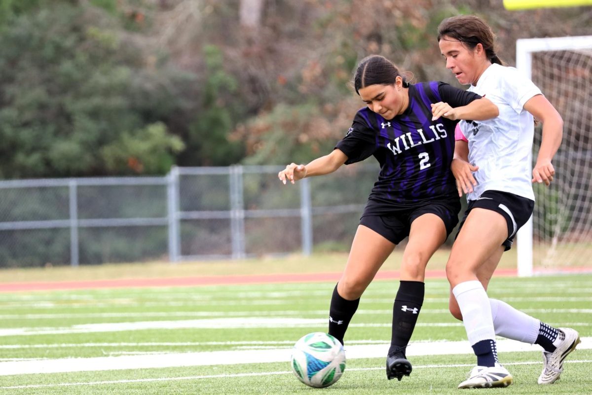 FIGHTING TO WIN. During the Kat Kup held Jan. 8-10, junior Rylie Eliff fights a player from Ysleta Hanks. The Kats struggles to get in the goal and finished 0-1 against the Knights. photo by Sujeidy Ortiz