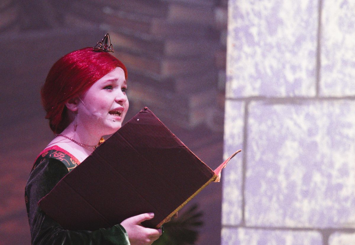 STORYBOOK PRINCESS.  Starring as Young Fiona, 5th grader Ellie Wiggins sings in the musical Shrek. Members of the Willis ISD Honor choir participated in the musical for the first time this year. 