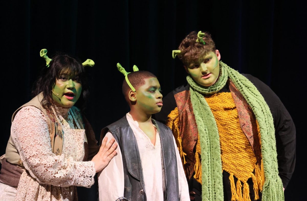 NOT EASY BEING GREEN. Mama Ogre (Avalon Baretto) and Papa Ogre (Elijah Fondren) tells Baby Ogre (Kaleb Cipriani) it is time for him to strike out on his own. 