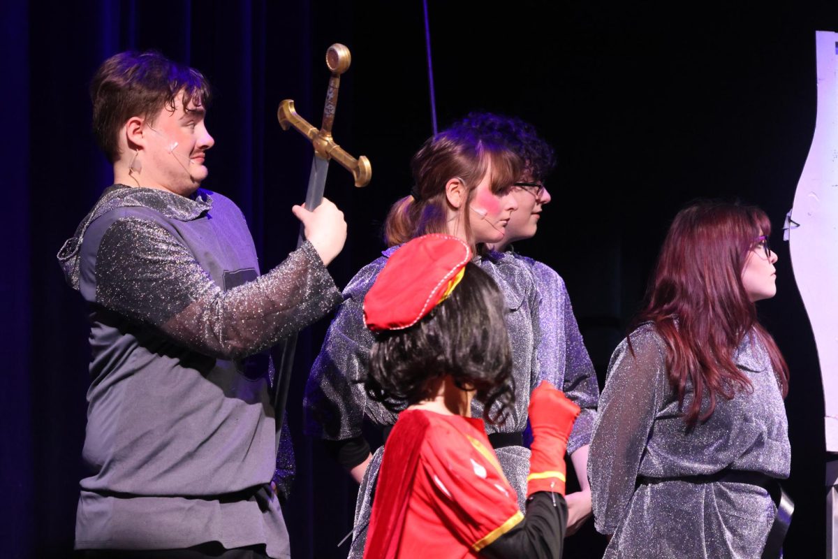 ON GUARD. Guarding Lord Farquard (sophomore Austin Montalnbano) the knights (senior Alexzander Talkington, junior Haile Glass sophomore Carter Bernard and junior Erica  Sears) take the stage in the scene that introduces kingdom of Duloc to the musical. 