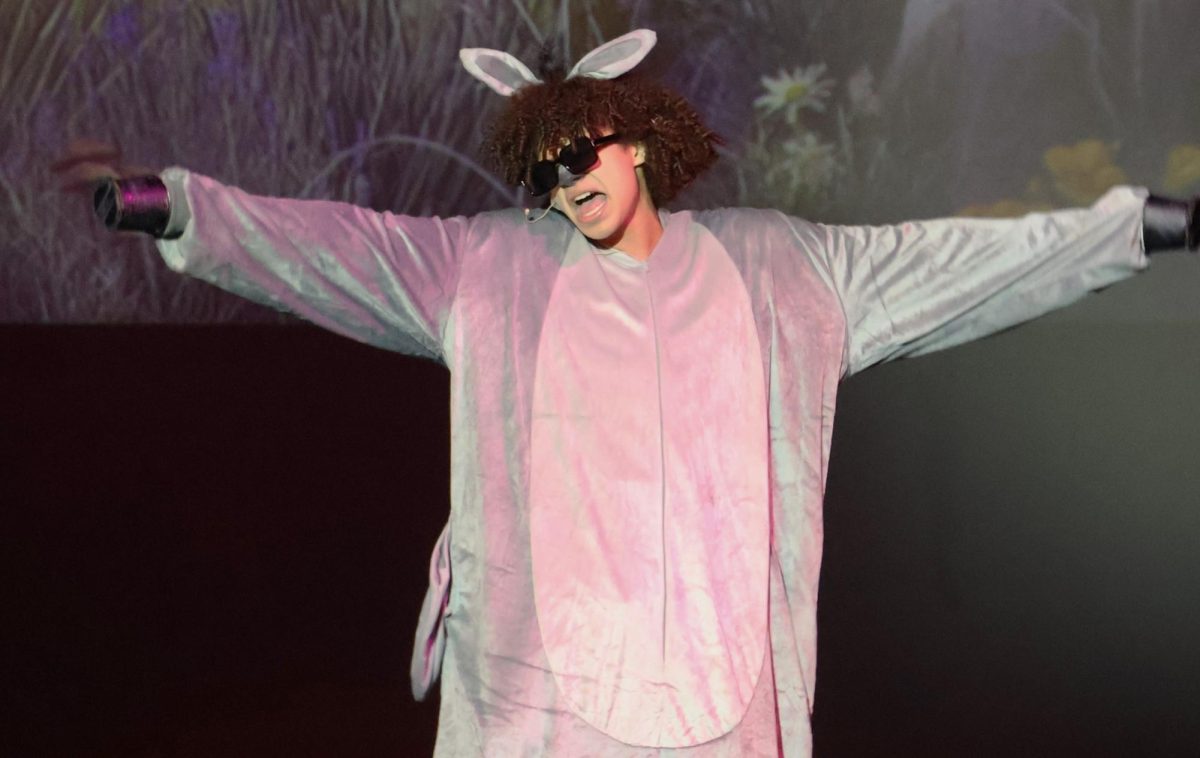 ROAD TRIP READY. Donkey (sophomore Chege Wechege) sings Make a Move during the Shrek performance on Friday morning. The cast performed for some middle students. 