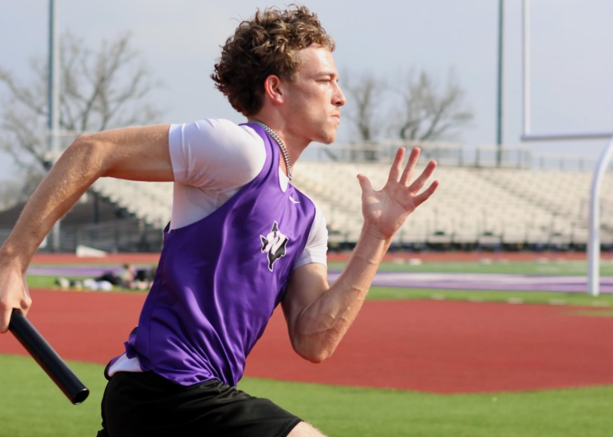 Running in the 4x400 relay last week, junior Carter Isom speeds down the track during his leg of the race. 
