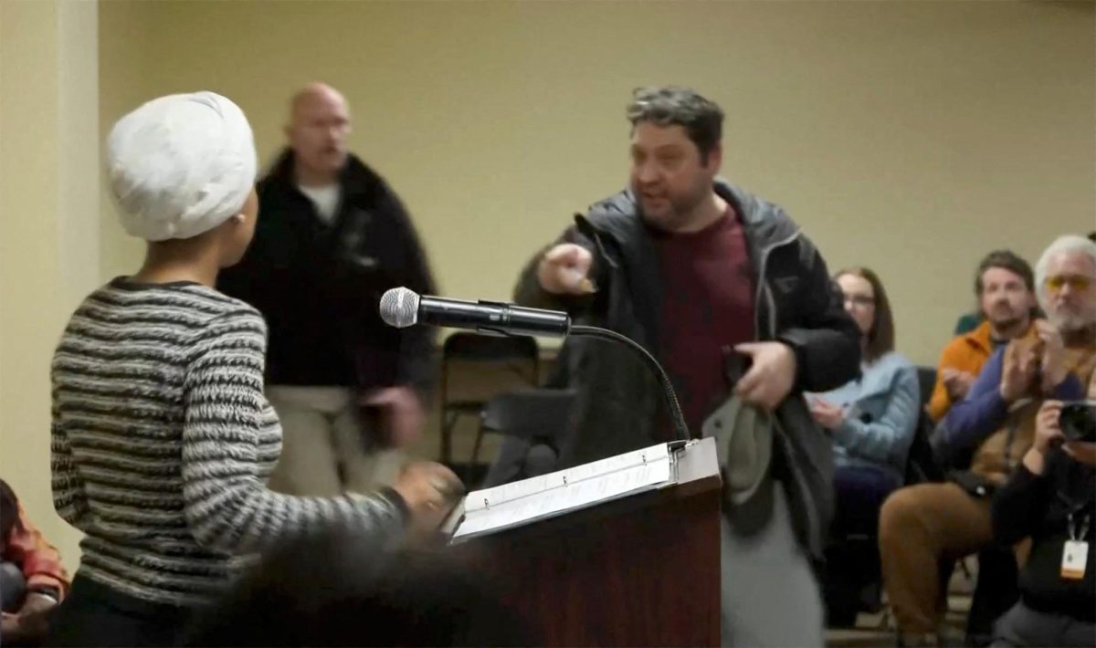 A man shouts at U.S. Representative Ilhan Omar (D-MN) after spraying her, during a town hall meeting days after a man identified as Alex Pretti was fatally shot by federal immigration agents trying to detain him, in Minneapolis, Minnesota, U.S., January 27, 2026, in a still image from video. REUTERS/Maria Alejandra Cardona