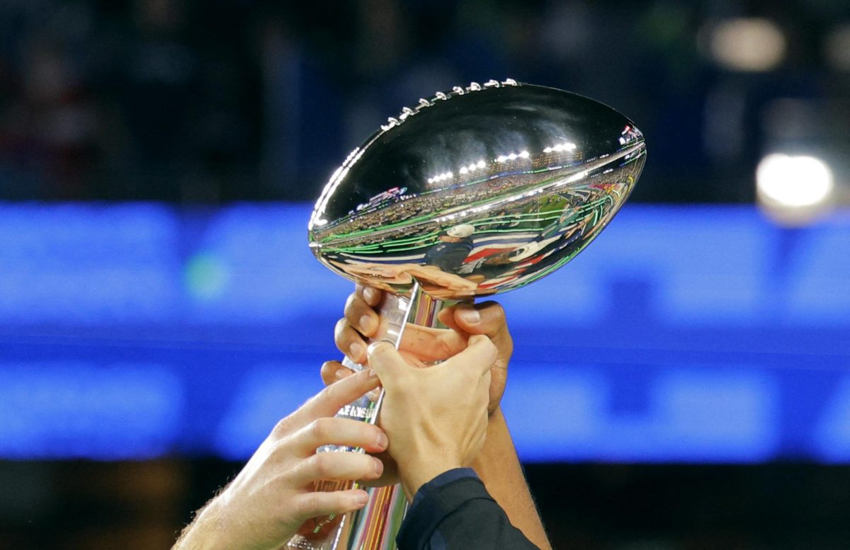Football - NFL - Super Bowl LX - New England Patriots v Seattle Seahawks - Levi's Stadium, Santa Clara, California, United States - February 8, 2026 Seattle Seahawks players hold aloft the Vince Lombardi Trophy as they celebrate after winning Super Bowl LX REUTERS/Mike Blake