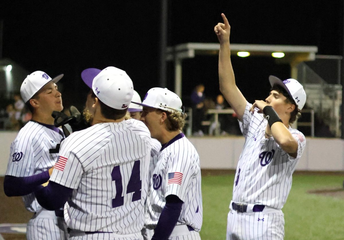 GREAT JOB KATS. Celebrating after a great inning, junior Kash Abke comes into the dugout with his teammates