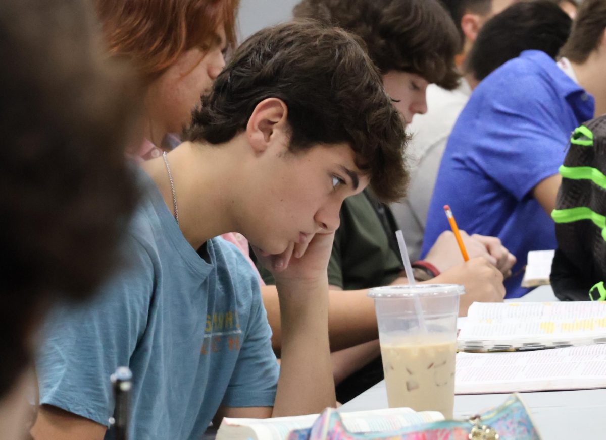 EARLY MORNING BIBLE STUDY. At a Wednesday morning FCA meeting, sophomore Finley Ashley listens to the message. 