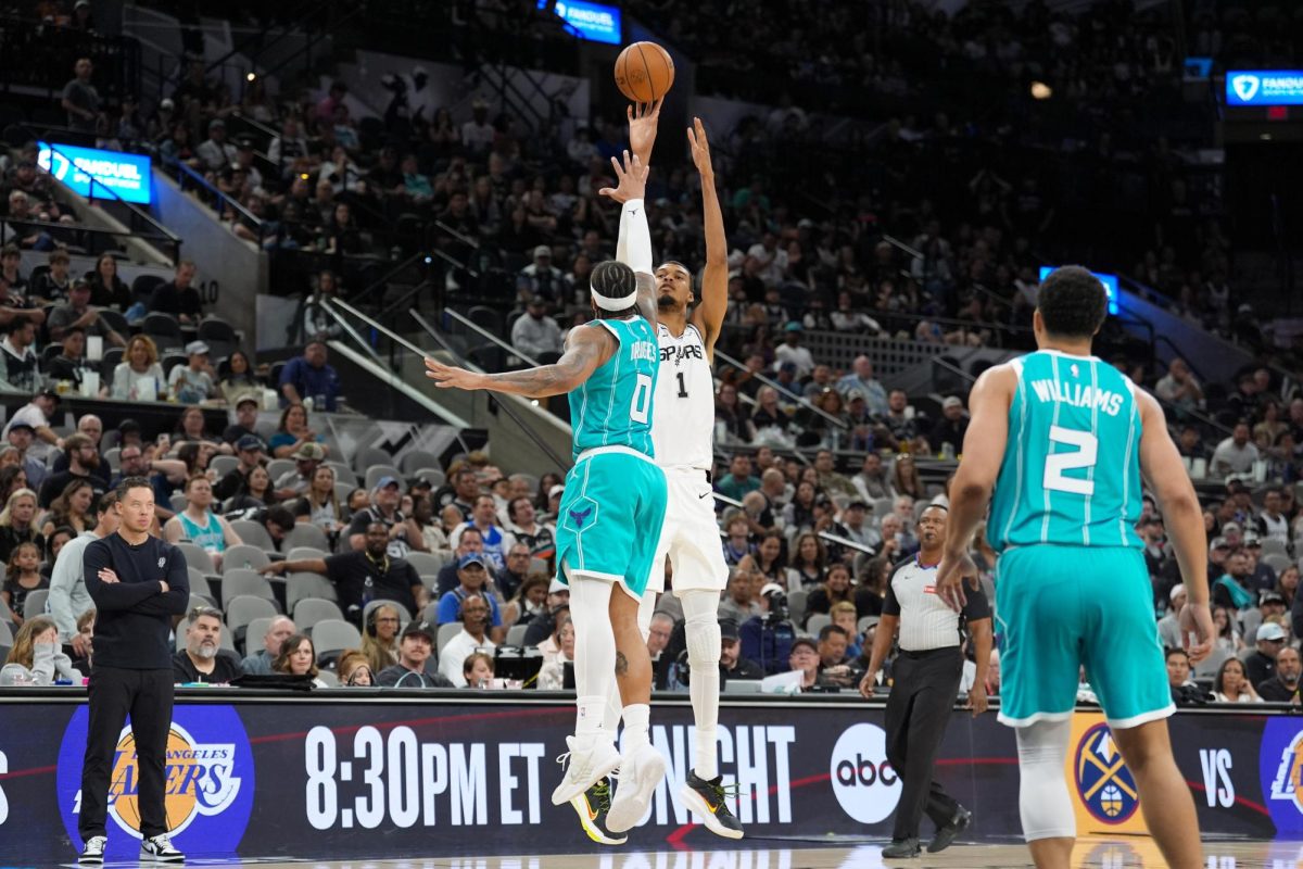 Mar 14, 2026; San Antonio, Texas, USA;  San Antonio Spurs forward Victor Wembanyama (1) shoots over Charlotte Hornets forward Miles Bridges (0) in the second half at Frost Bank Center. Mandatory Credit: Daniel Dunn-Imagn Images