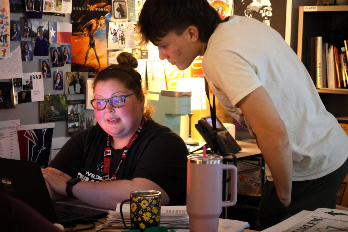 HISTORY HELPER. Teacher of the Year Whitney Van Cleve helps junior Wesley Burns with an assignment in DC US History class.  Van Cleve was elected to the top teacher award by her peers.