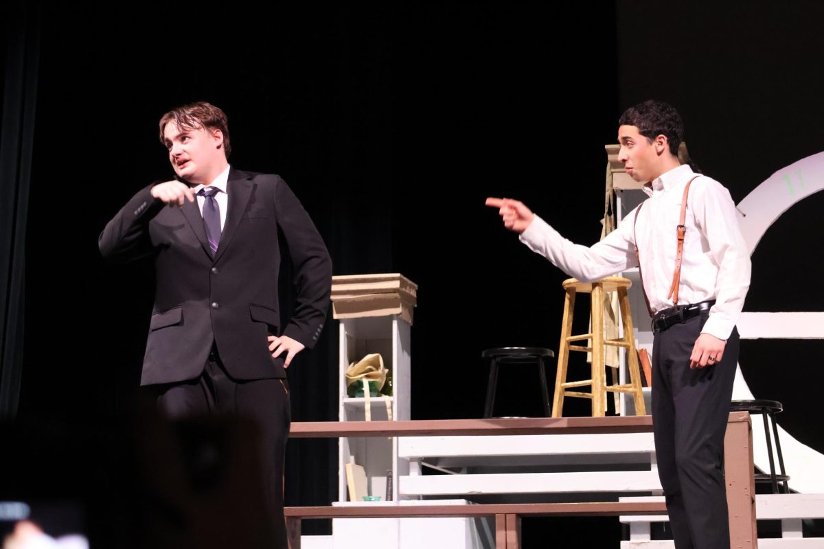 CONFRONTATION. At the trial involving his wife and Radium Dial Company, Tom Donohue (junior Luciano Baustista) confronts Mr. Reed (senior Alexzander Talkington) about the danger his wife faced under Reed's employment. 