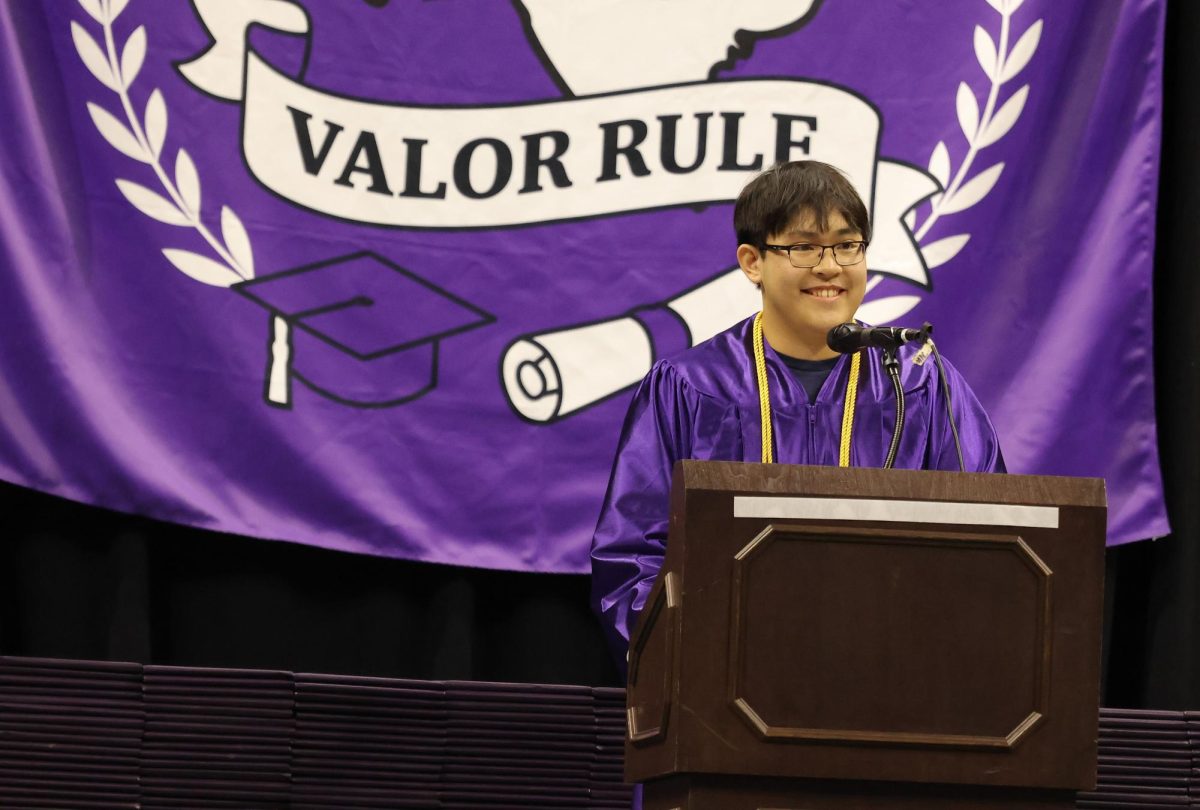NUMBER ONE. Giving his address as valedictorian, senior Chris Luong imparts his wisdom and a few jokes to the crowd. 