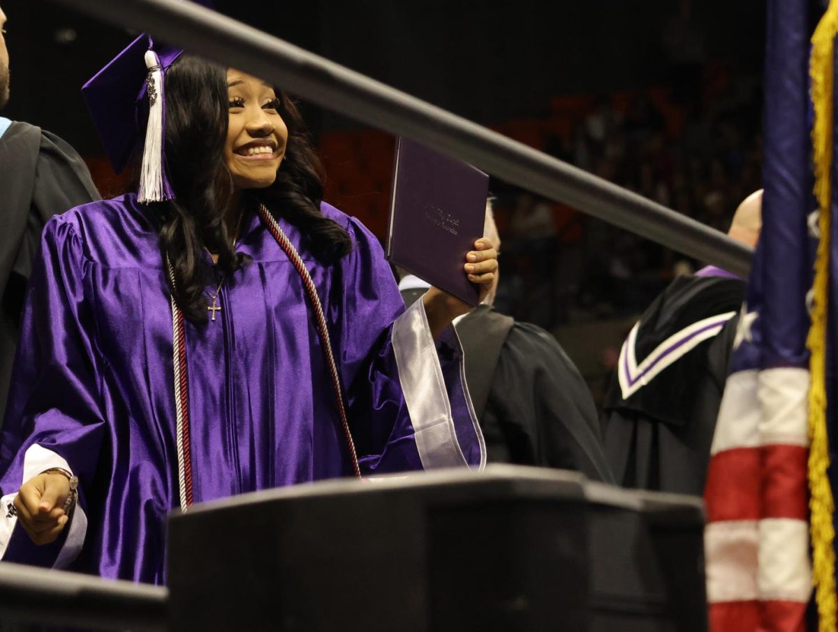 ALL SMILES.  Looking to the crowd, senior Sujeidy Ortiz walks off the stage after receiving her diploma. 